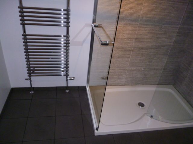Wet room with dark slate tiles and shower tray