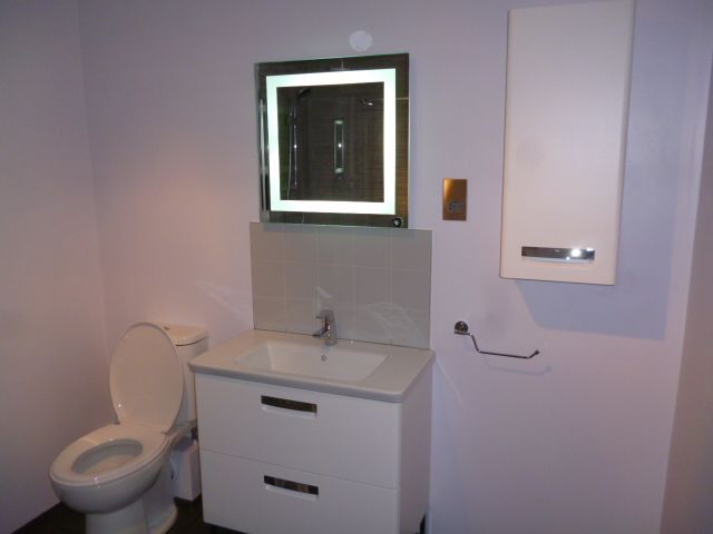 Contemporary bathroom refit with lit mirror