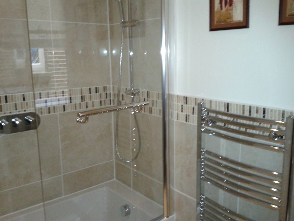 Walk-in shower with heated towel rail